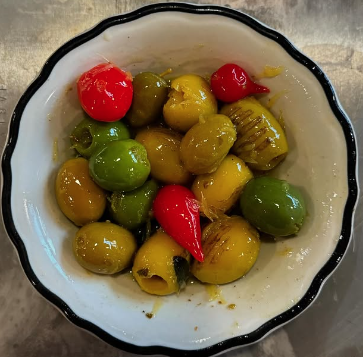 an array of olives in various colors in a dish